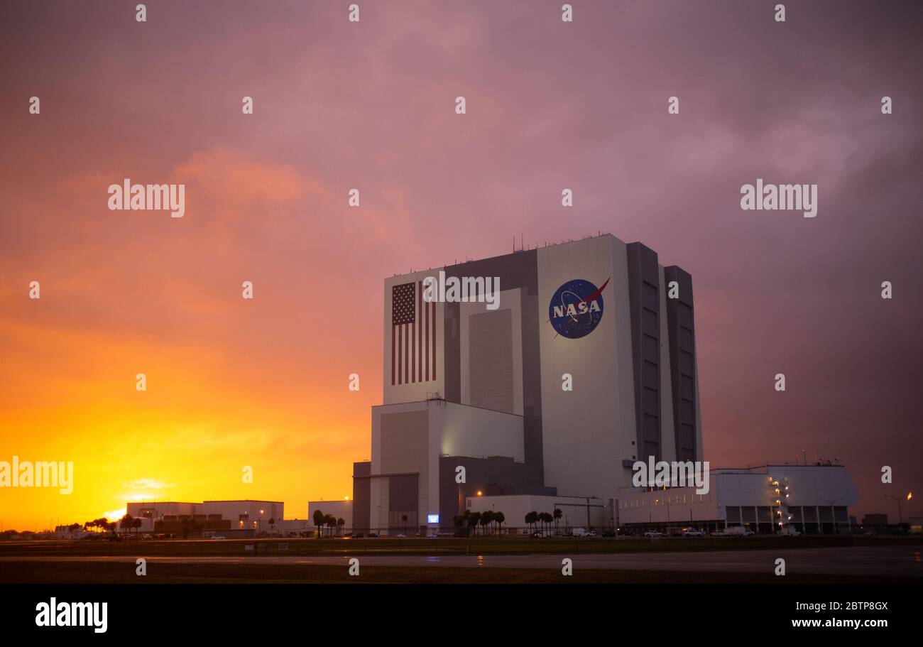 The NASA Vehicle Assembly Building at sunset as preparations continue for the launch of the SpaceX Falcon 9 rocket carrying the Crew Dragon spacecraft at the Kennedy Space Center May 25, 2020 in Cape Canaveral, Florida. The NASA SpaceX Demo-2 mission is scheduled for launch May 27th as the first commercial launch carrying astronauts to the International Space Station. Stock Photo