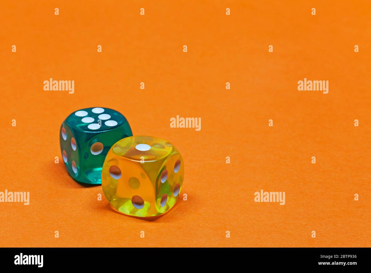 two transparent dice on orange background Stock Photo