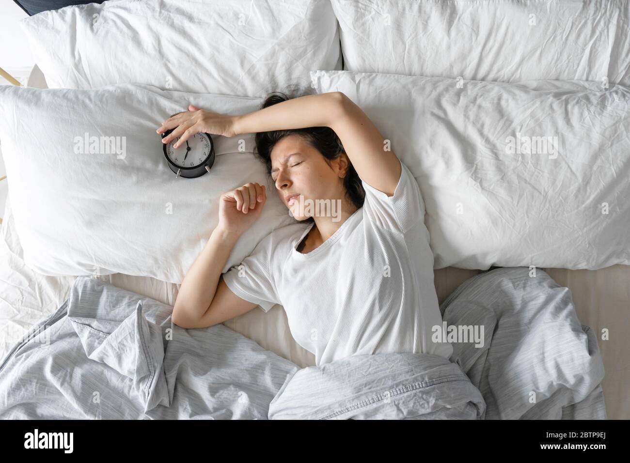 Young woman sleeping bed from above hi-res stock photography and