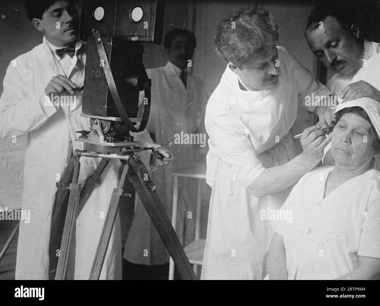 New faces for old . Dr Raymond Passot , a celebrated French surgeon , who is to lecture at the French Institute , London . Dr Passot demonstrating before a cinema camera . 16 March 1927 Stock Photo