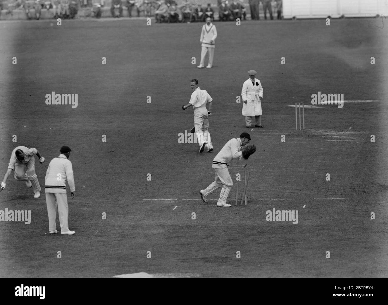 Shattering the wicket . Stan Nichols , the Essex batsman , was nearly run out when Edward Brooks the Surrey wicket keeper , shattered the wicket from a sharp return in the match at Leyton on the first day of the County Championship . 20 June 1931 Stock Photo