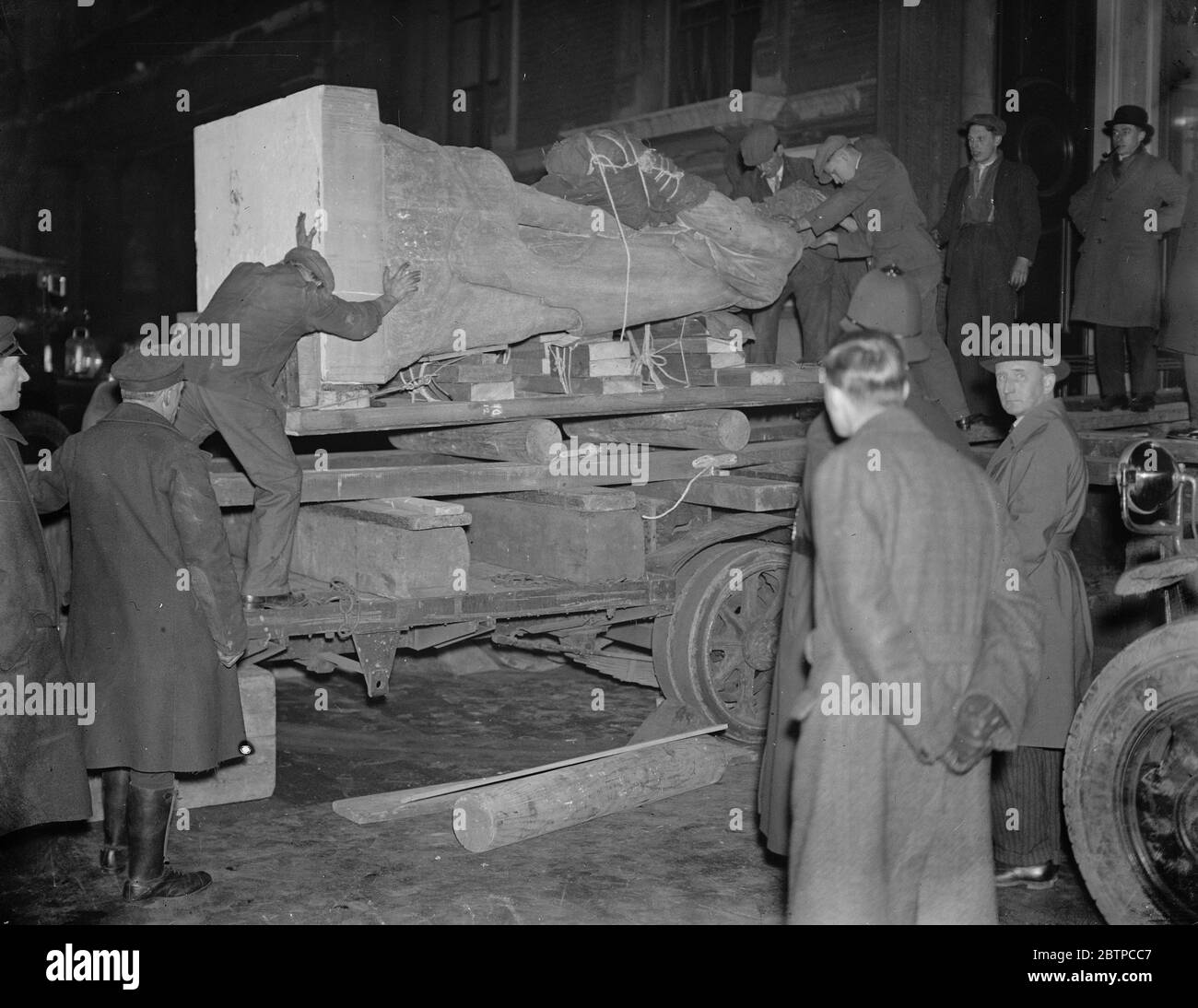 A herculean task . A giant statue of Hercules was removed in the early hours of the morning from the Jermyn street branch of the Victoria and Albert Museum to the South Kensington building . The huge statue being placed in position on the trailer . 27 February 1932 Stock Photo