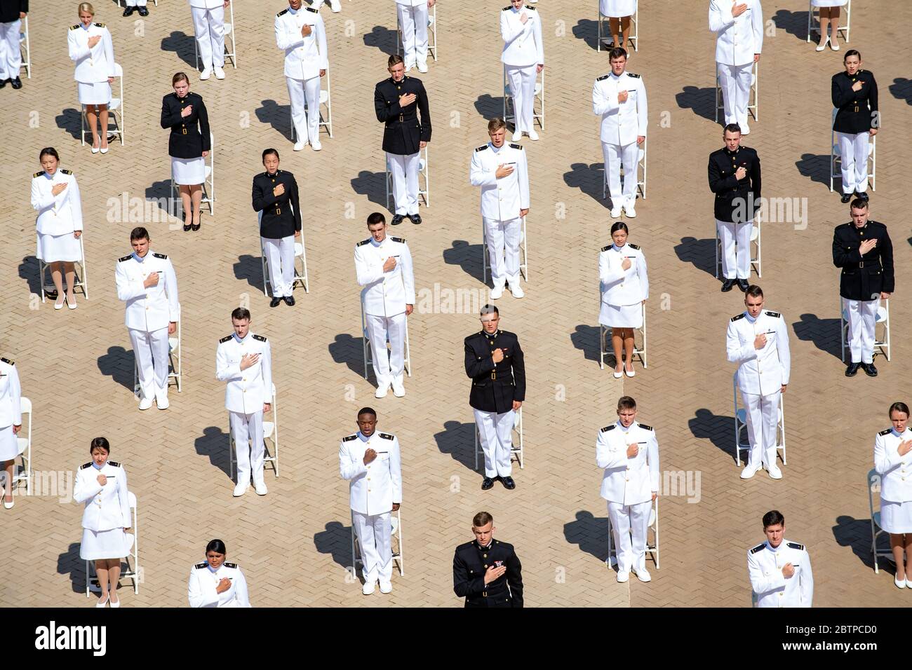 U.S. Naval Academy midshipmen during the commencement and commissioning ceremony for the Naval Academy Class of 2020 under COVID-19, coronavirus pandemic social distancing rules May 14, 2020 in Annapolis, Maryland. Approximately 1,000 midshipmen will graduate and be sworn-in during five events and one virtual ceremony. Stock Photo