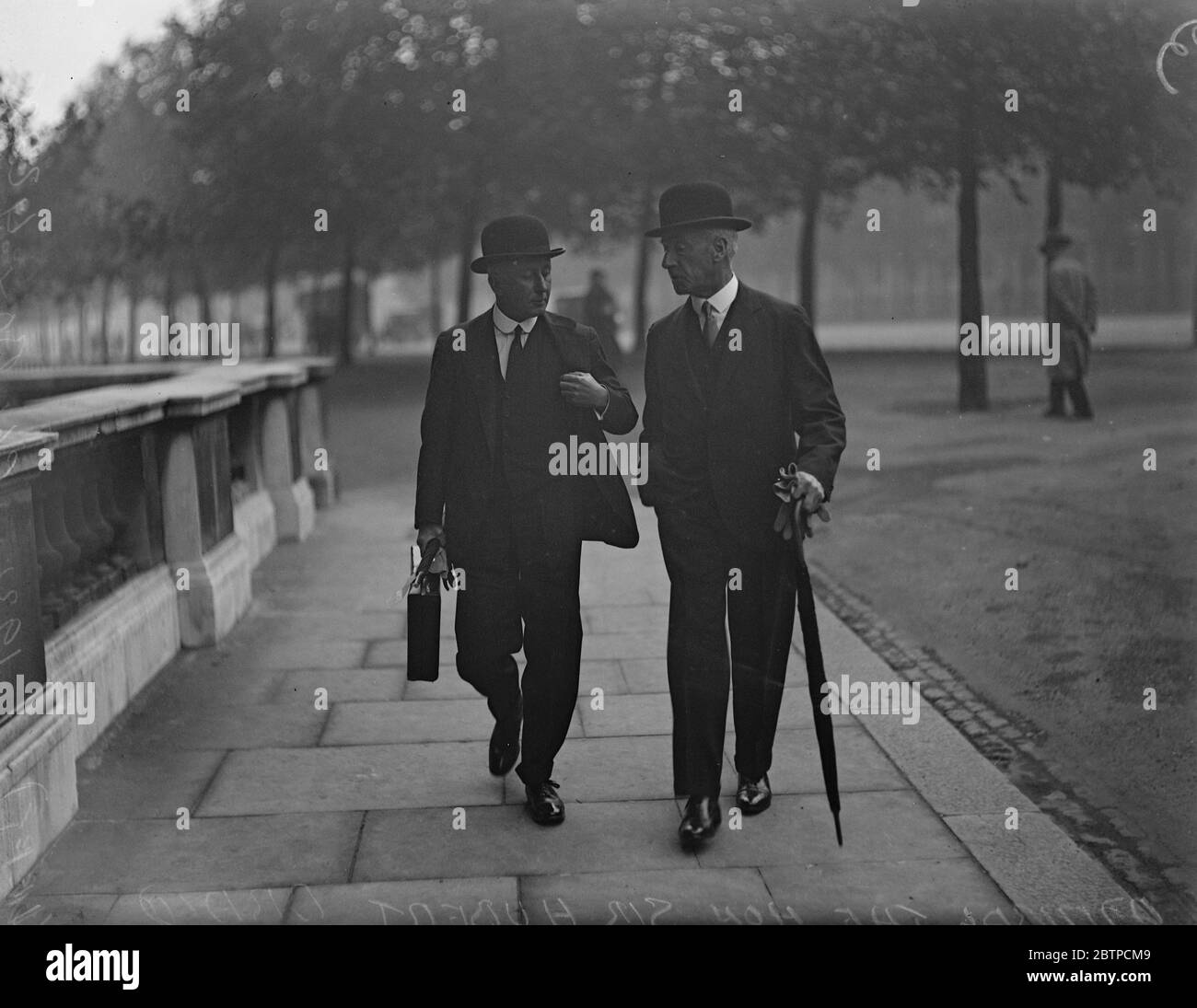 Admirals attend Whitehall conference . Admiral the Honourable Sir Hubert Brand ( left ) ( Devonport Station ) in earnest conversation with a friend on arrival at the Admiralty . 18 September 1931 Stock Photo