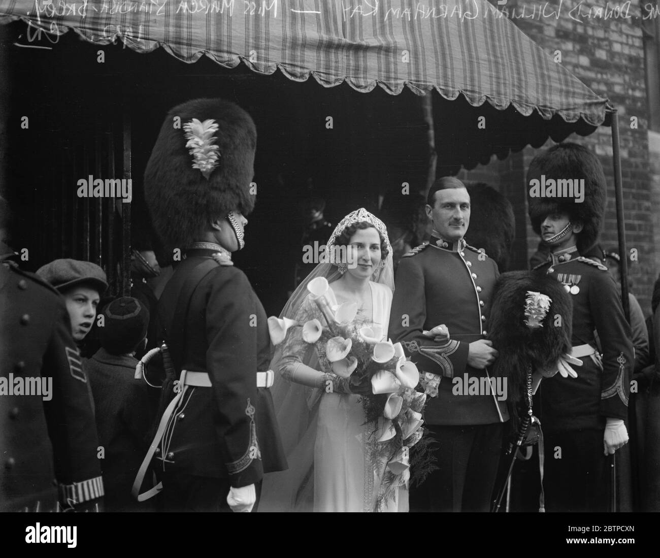 Pretty London society wedding . Miss March Standish Barry , daughter of Miss St John Montague was married to Mr Donald William Garnham Ray, at Holy Trinity , Brompton . 7 December 1932 Stock Photo