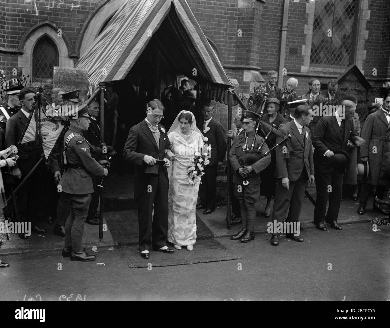 Premier 's daughter married . Dr Joan MacDonald was married to Dr Alastair Mackinnon at the Congregational Church , Wendover . The bride and bridegroom leaving after the ceremony . 20 September 1932 Stock Photo