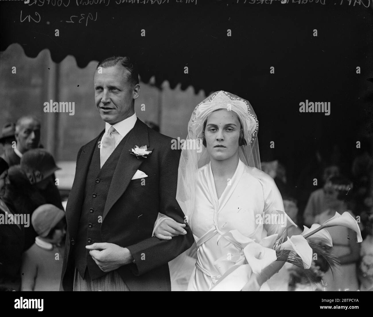 A military bridegroom . The marriage between Captain Douglas Brett , Indian Army , and Miss Roxalanne ( Noggs ) Cooper at Holy Trinity Church , Prince Consort Road , on Thursday . The bride and bridegroom . 29 September 1932 Stock Photo
