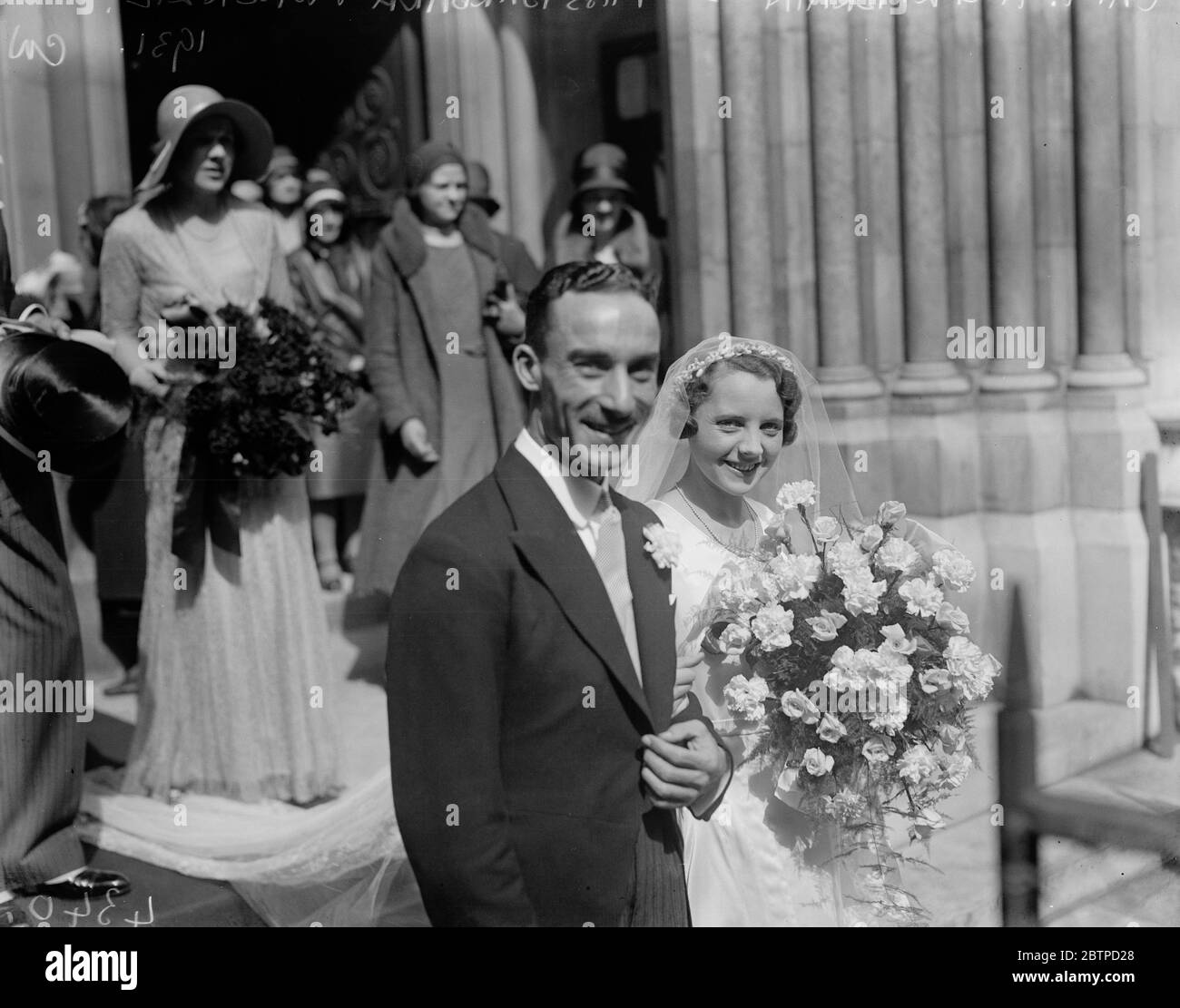 Society wedding . The wedding of Capt H G L Brain and Miss Barbara Mackenzie at St James ' s Church , Spanish Place . The smiling bride and bridegroom . 19 August 1931 Stock Photo