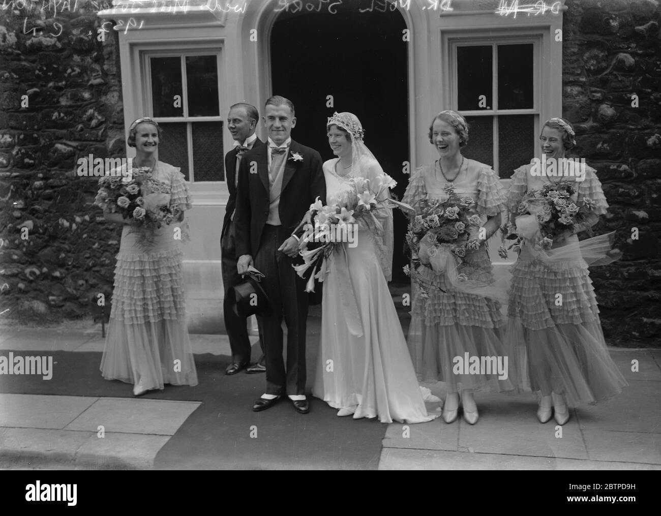 A Westminster Abbey wedding . The marriage between Dr Noel Storr and Miss Joyce Taynton took place in Henry VIII 's Chapel , Westminster Abbey . The bride and bridegroom with bridal attendants . 1 September 1932 Stock Photo
