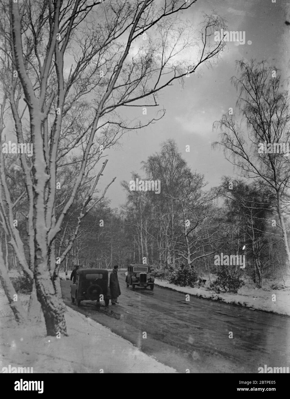 Driving in the snow . 1935 . Stock Photo