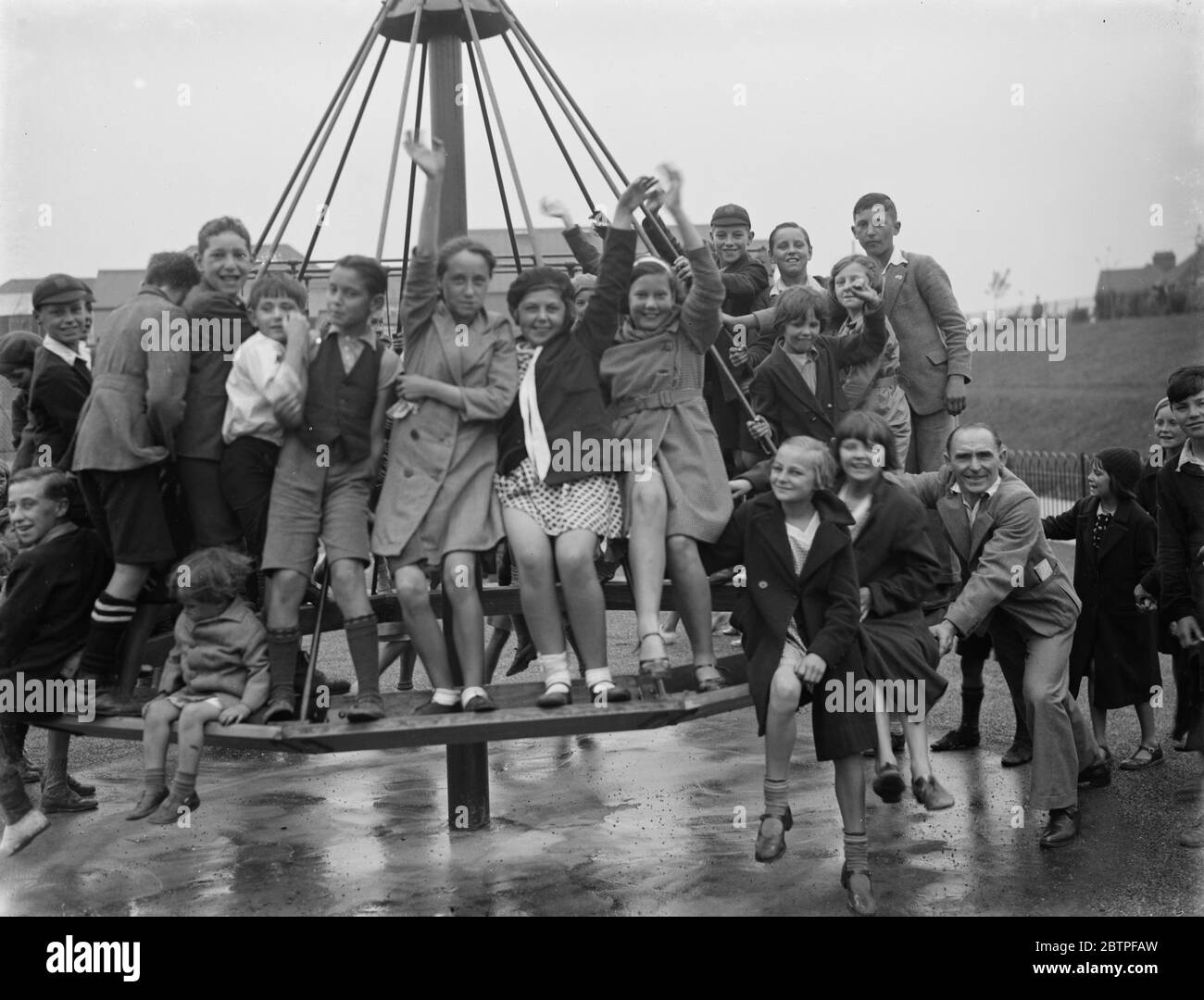 Crayford playground is opened . Children swing on the maypole swing . 1936 . Stock Photo