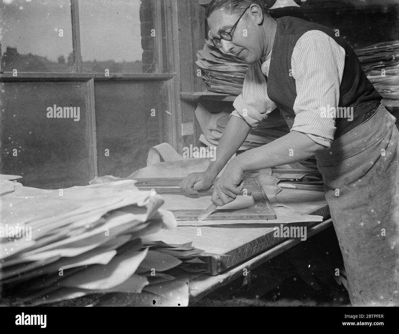 Vellum works series . A worker making out and finishing the vellum