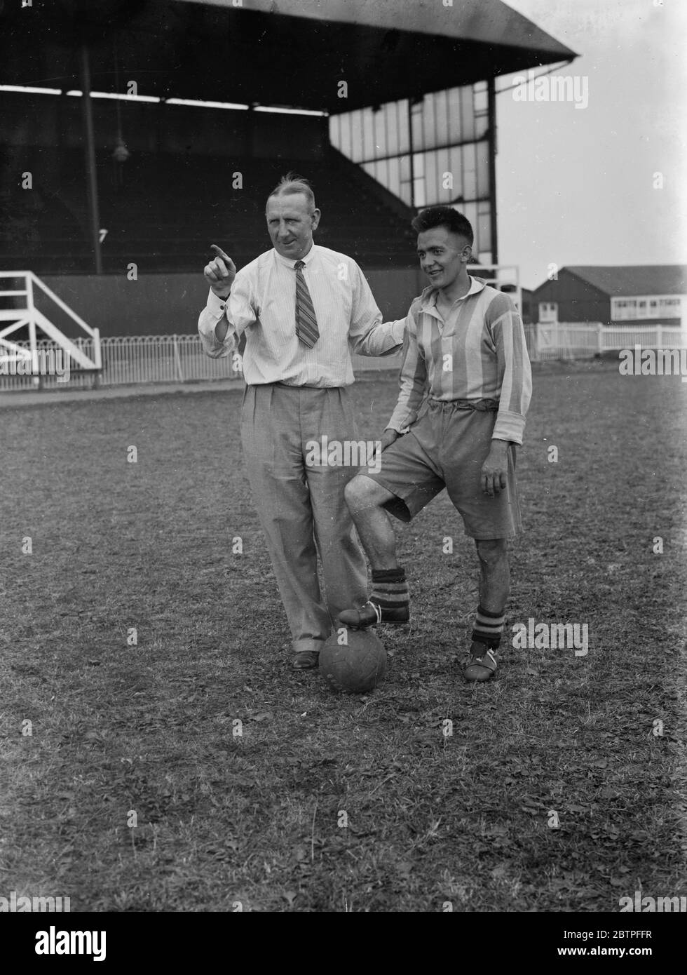 Footballers at Dartford . A manager talks tactics to one of his players . 1936 Stock Photo