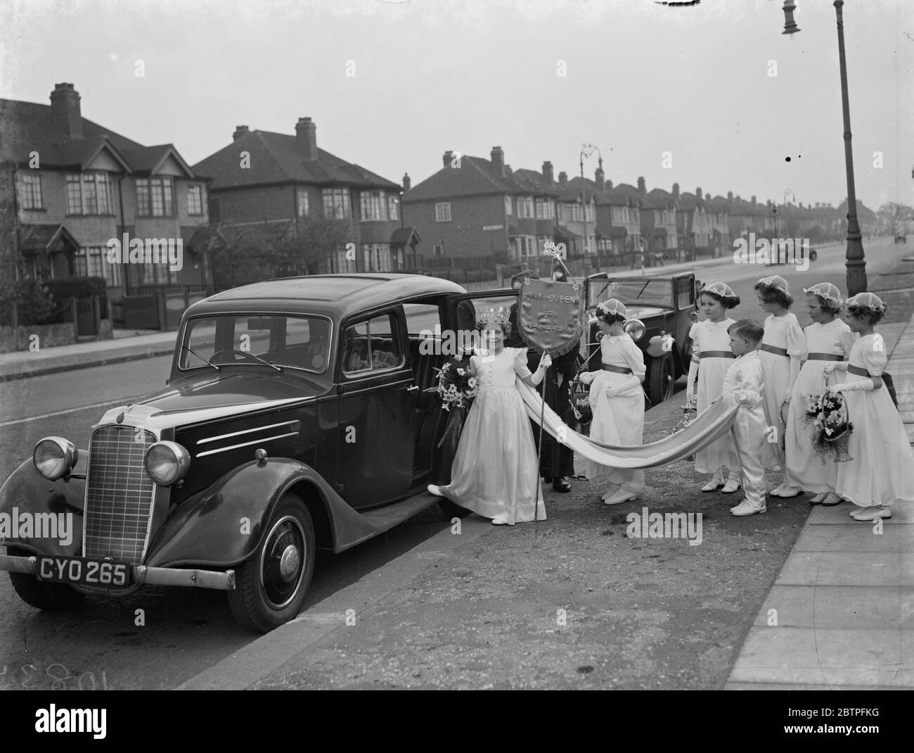 May Day festivities . Miss Peggy Sims the New Eltham May Queen leading her retinue to a car . 6 May 1939 Stock Photo