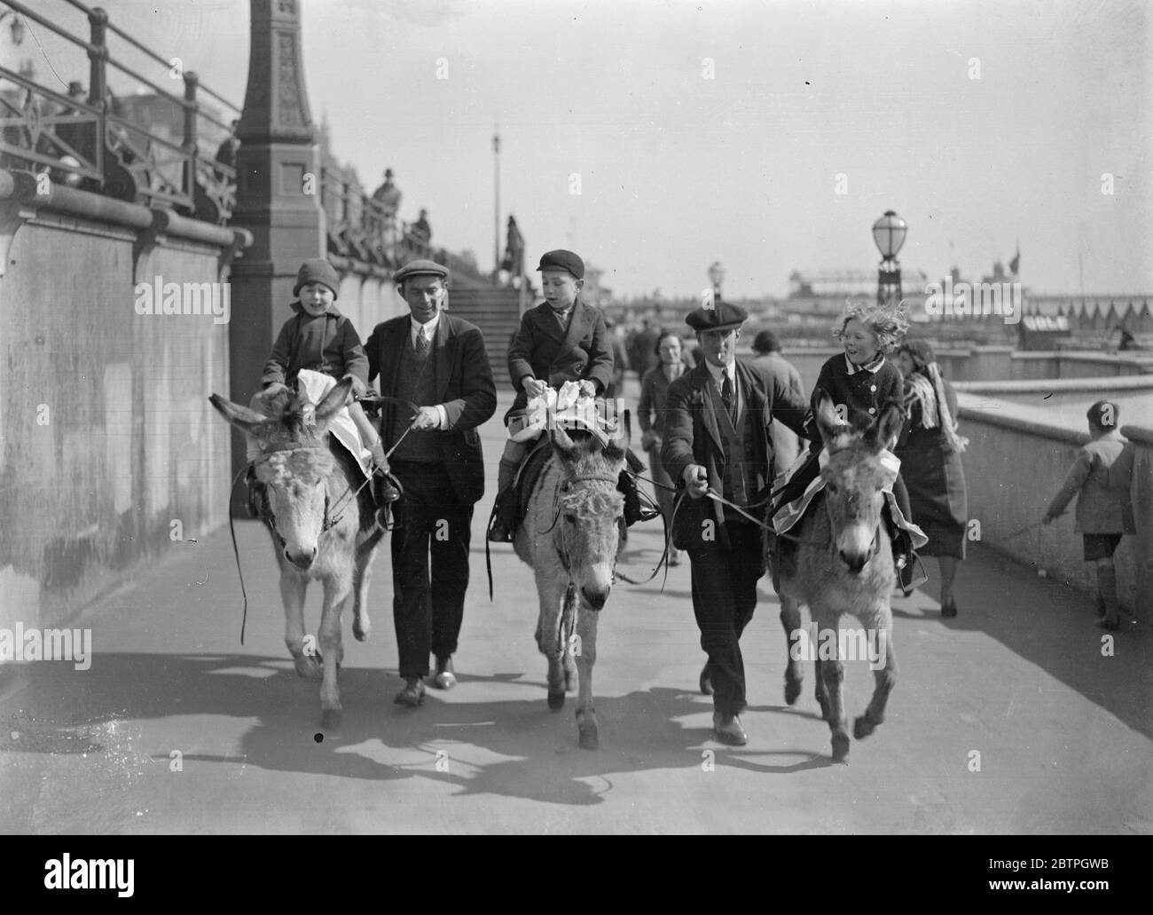 Holiday fun at Brighton . Children enjoying donkey rides in the sunshine at Brighton where the Easter holiday crowds have surpassed all expectations . 27 March 1932 Stock Photo