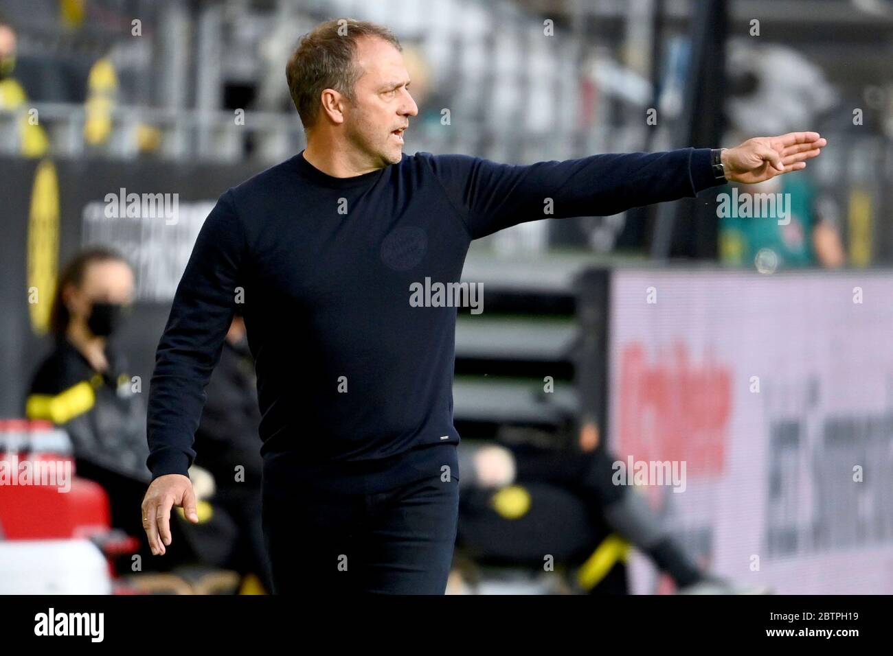Munich's head coach Hansi Flick gestures during the German Bundesliga soccer match between Borussia Dortmund and FC Bayern Munich in Dortmund, Germany. Stock Photo