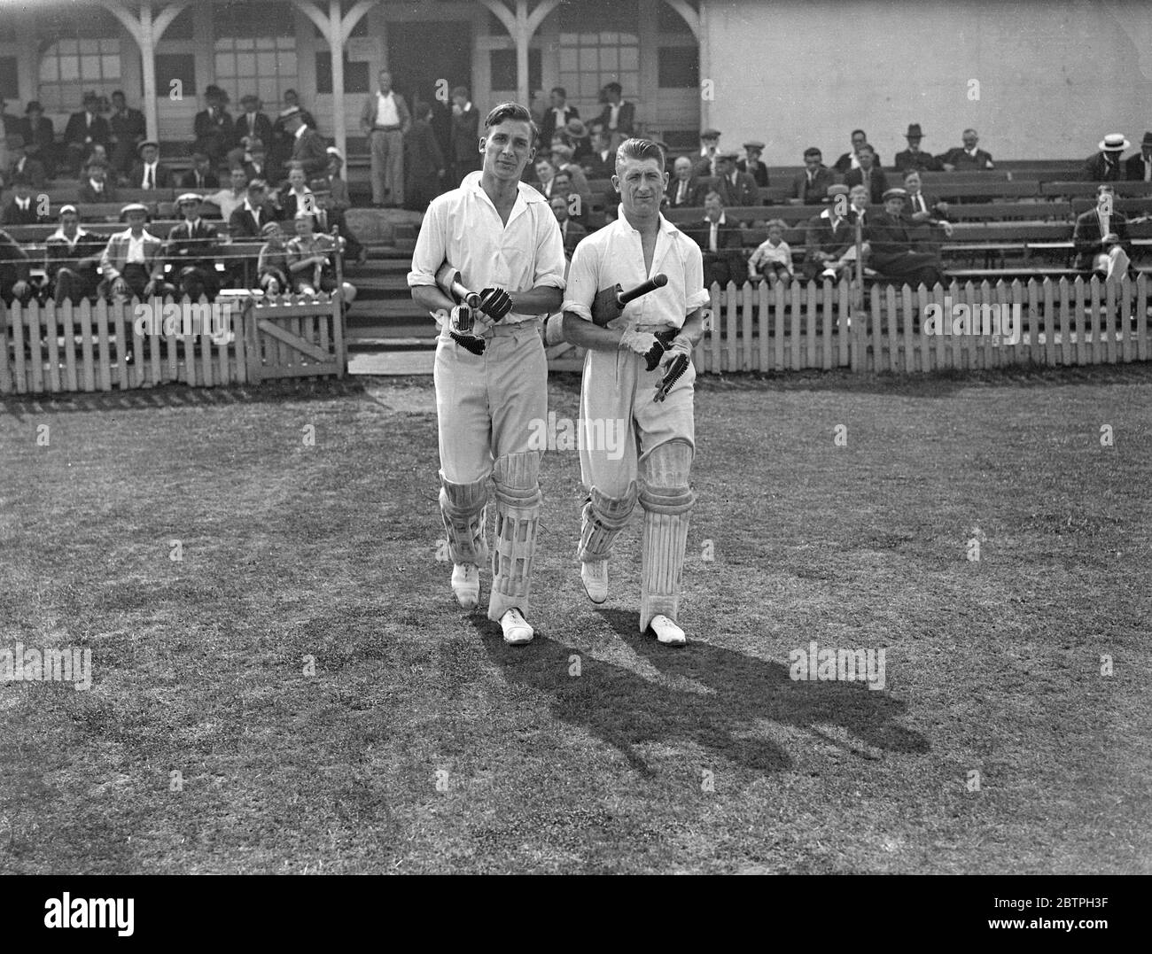 Footballers at cricket . West Ham met Clapton Orient in a cricket match at the Essex County Cricket Ground at Leyton . E Fenton ( left ) and W Fryatt of West Ham , going out to bat . 17 August 1932 Stock Photo