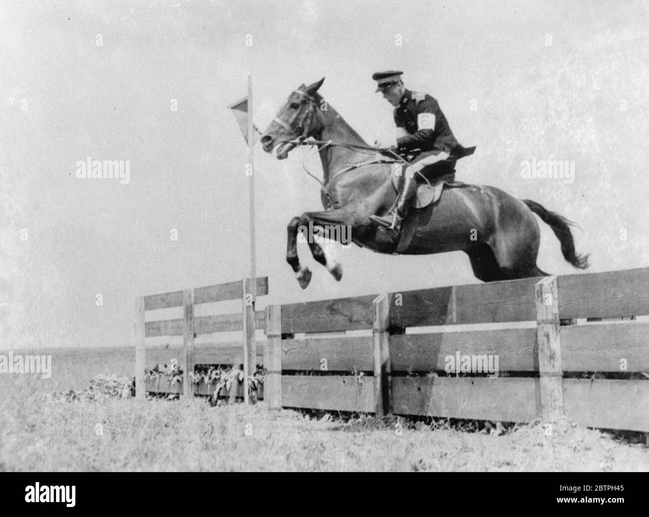 In Olympic pentathlon . Vernon W Barlow of Great Britain clears one of the jumps during the riding event , the modern pentathlon at the Los Angeles Olympiad . 1932 Stock Photo