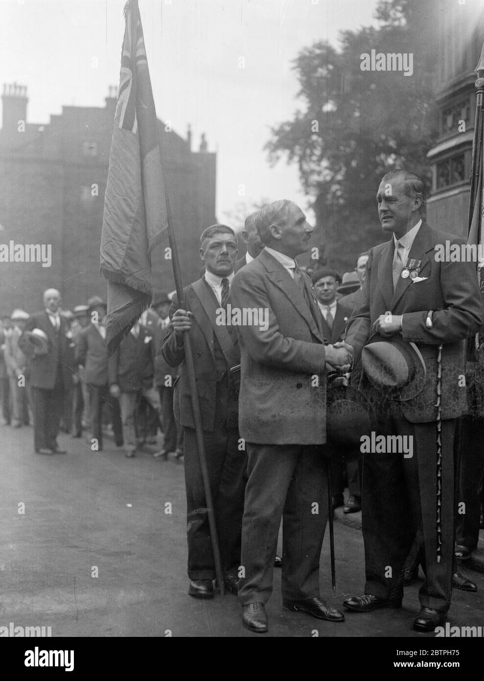 French veterans visit London . 550 French war veterans and their wives spent Sunday in London , visiting places of interest . Captain Ian Fraser shaking hands with Private Argnot of the Havrs , who was blinded in same year as Captain Fraser at the Houses of Parliament . 14 August 1932 Stock Photo