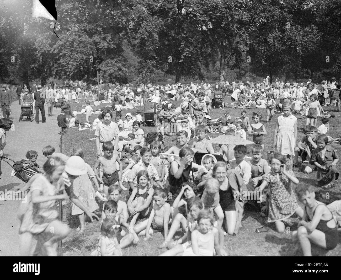 On holiday . Schoolchildren , who have just broken up for summer holidays crowd into St James ' s Park , London . 26 July 1935 Stock Photo