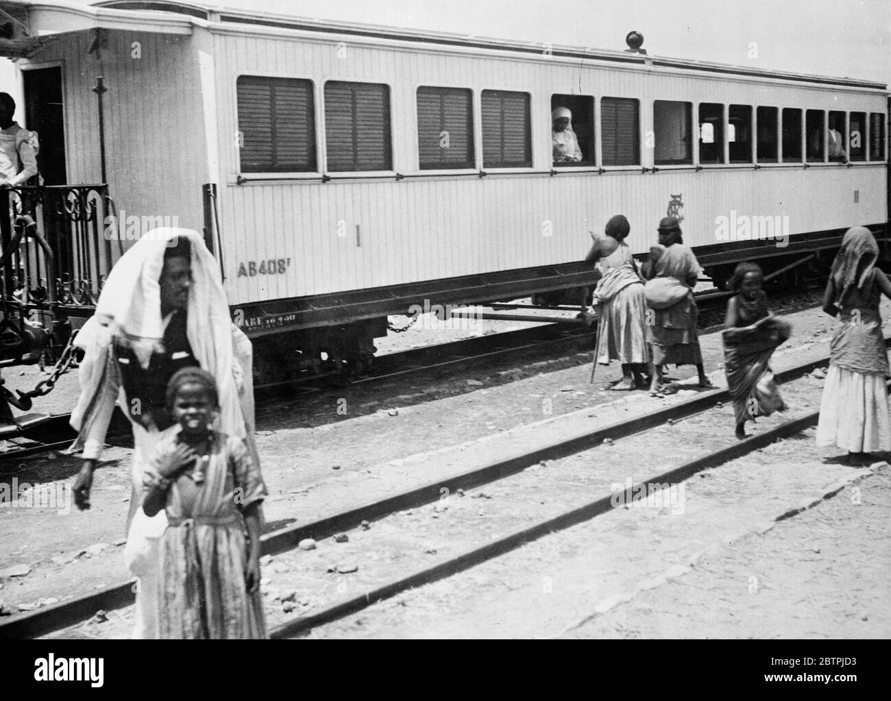 Foreigners leave Addis Ababa . Photos shows , crowds of foreigners from Abyssinia capital as a result of the war scare . Beggars soliciting alms from first class carriages as the train bearing foreigners left Addis Ababa for Djibouti , French Somaliland . 11 July 1935 Stock Photo