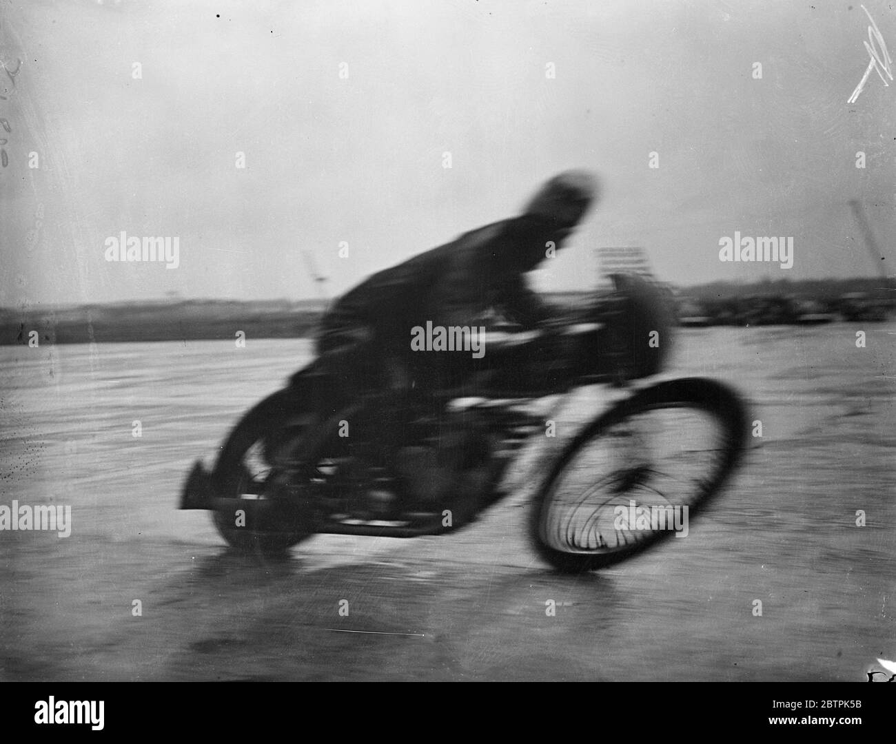 Ghost rider . Motor cycle racing season opens at Brooklands . The British Motor cycle racing club ' s first meeting opened the motor cycle racing season at Brooklands . Photo shows , an impression of speed as C B Bickell , riding an Ariel won the one lap Outer Circuit Handicap race at an average speed of 90 . 35 . 1 April 1936 Stock Photo