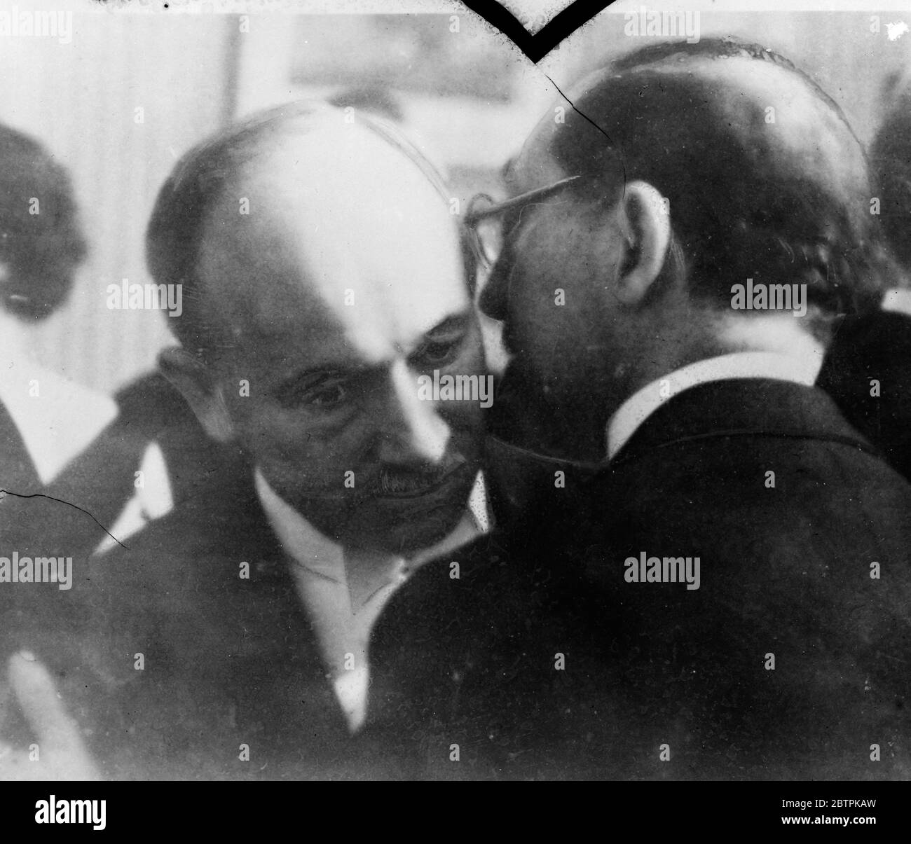 Geneva whispers . Towfik Fushdi Bey , the Turkish Foreign Minister , whispering a secret into the ear of Dr Benes , the Czechoslovakian Foreign Minister , at Geneva where both are attending the deliberations of the League on the Italo Abyssinian dispute . 24 September 1935 Stock Photo