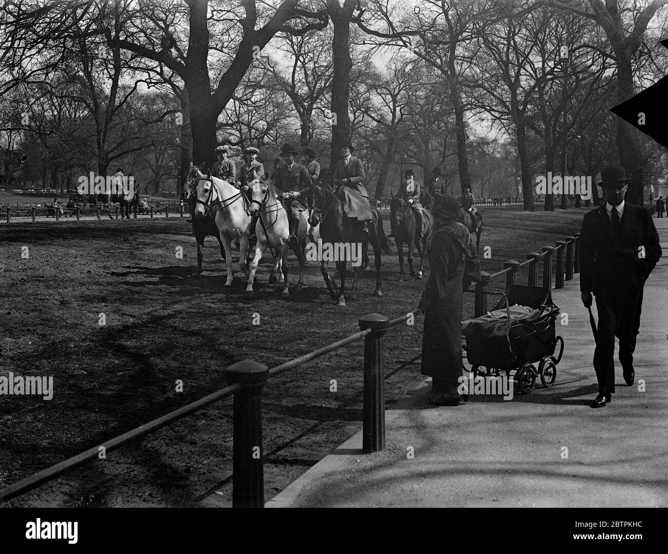 Spring retuns to London . Spring has again come to London after days of cold weather , and Londoners soon flocked to the parks and open spaces to take advantage of the warm sunshine . Photo shows , riders in the sunshine at Rotten Row , in Hyde Park . 18 April 1936 Stock Photo