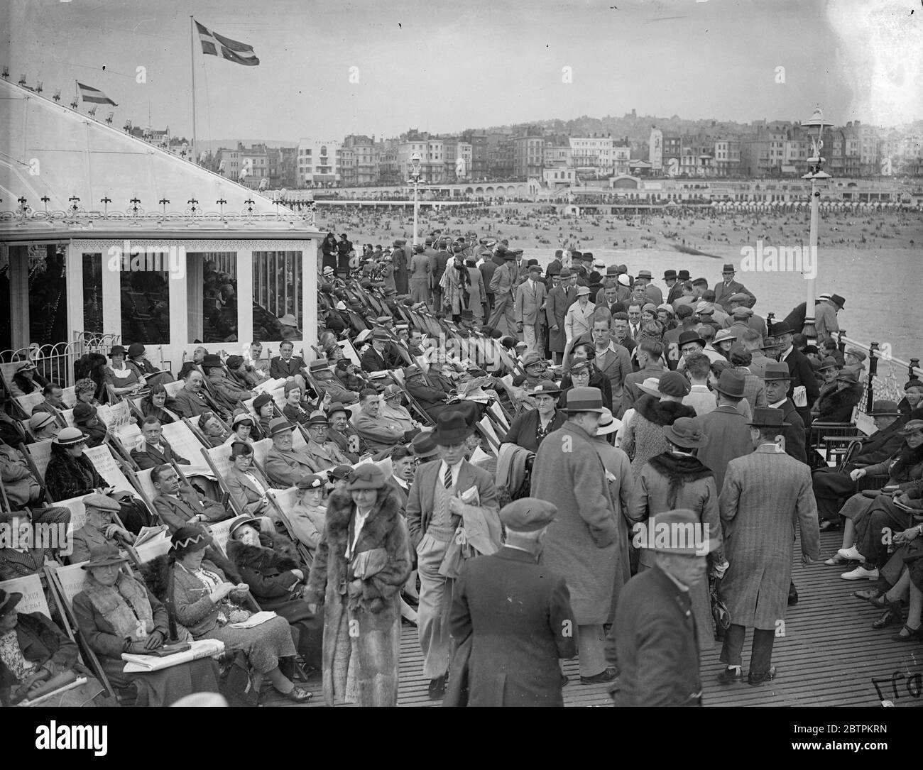 Whitsun on Palace Pier . ' Dr Brighton ' has a busy time ! . Large numbers of Whitsun holidaymakers went in search of the ever popular treatment of ' Dr Brighton ' . Brighton ' s Palace Pier provided a pleasant resting place for many visitors . Photo shows , the crowded Palace Pier , Brighton . 1 June 1936 Stock Photo