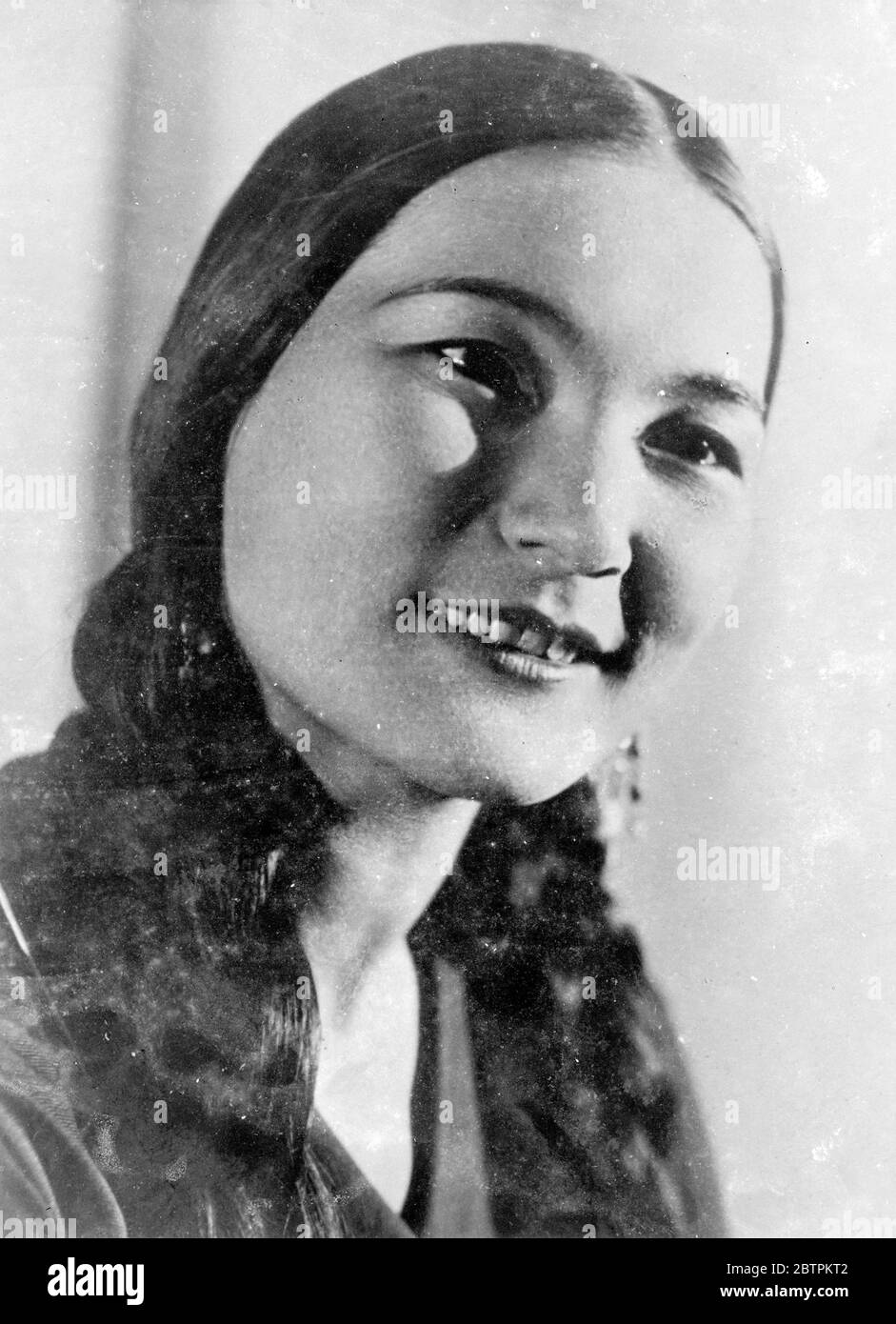 Smiling Beauty Of The East Smooth , oval features , dark eyes and reven hair draping graceful shoulders - this is the picture of Shara Zhandarbekova , agreed by experts to be a typical Kazakh beauty of Asiatic Russia . She has been trained as ballet dancer and is now drawing crowded audiences to the Kazakh State Musical Theatre . 2 Jun 1936 Stock Photo
