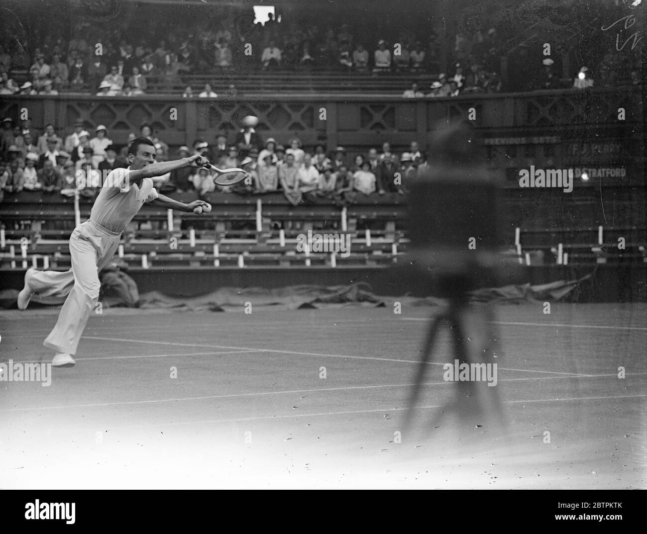 Wimbledon tennis championships open . Perry meets Stratford . Fred Perry in play against Stratford . 22 June 1936 Stock Photo