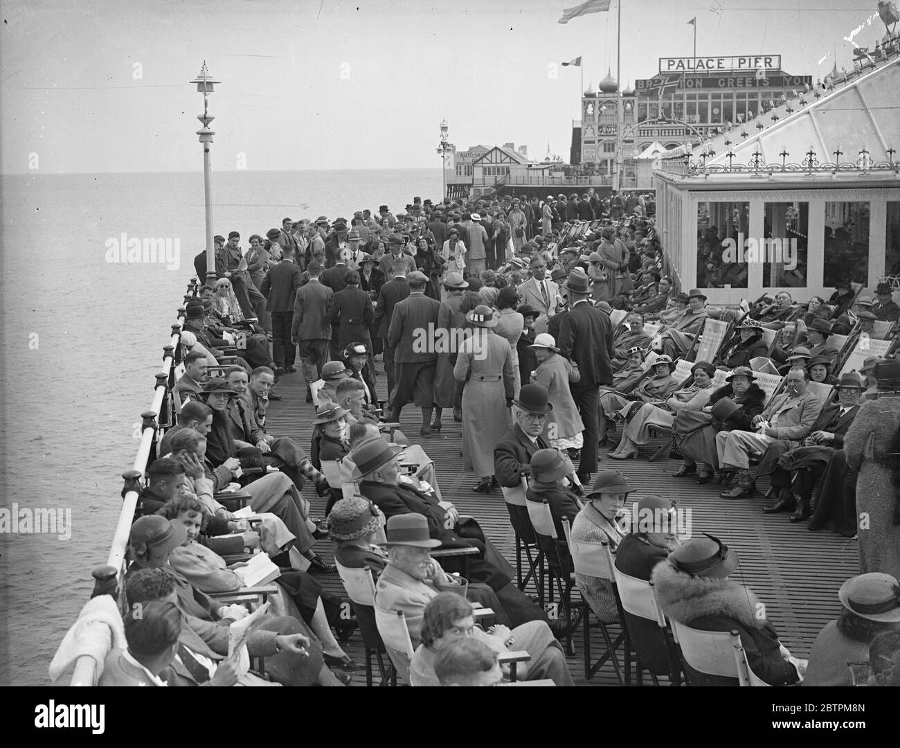 Whitsun on Palace Pier . ' Dr Brighton ' has a busy time ! . Large numbers of Whitsun holidaymakers went in search of the ever popular treatment of ' Dr Brighton ' . Brighton ' s Palace Pier provided a pleasant resting place for many visitors . Photo shows , the crowded Palace Pier , Brighton . 1 June 1936 Stock Photo