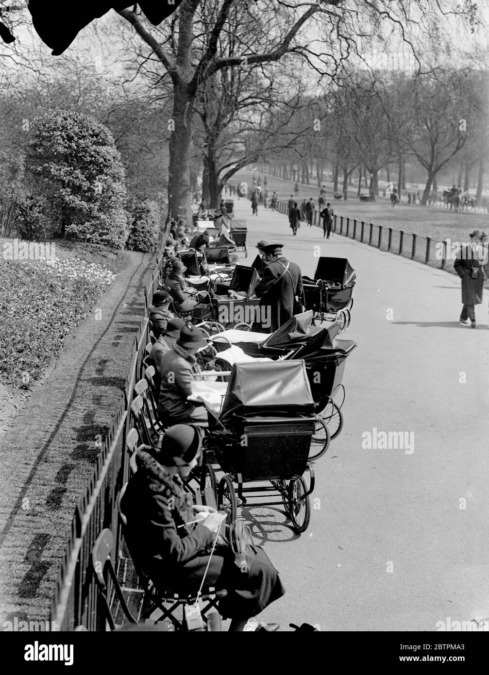 Spring retuns to London . Spring has again come to London after days of cold weather , and Londoners soon flocked to the parks and open spaces to take advantage of the warm sunshine . Photo shows , Perambulators ' parked by the Row in Hyde Park . 18 April 1936 Stock Photo