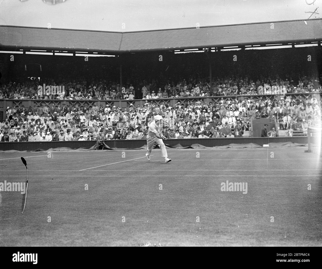 American Duel At Wimbledon . Allison Defeats Jones In Singles . After a stern duel Wilmer Allison ( USA ) defeated his fellow - American David N . Jones 14 - 12 , 6 - 3 , 6 - 4 in the men ' s singles of the WimbledonTennis Championships . Photo Shows : Wilmer Alisson in play against Jones on the Centre Court . 24 Jun 1936 Stock Photo