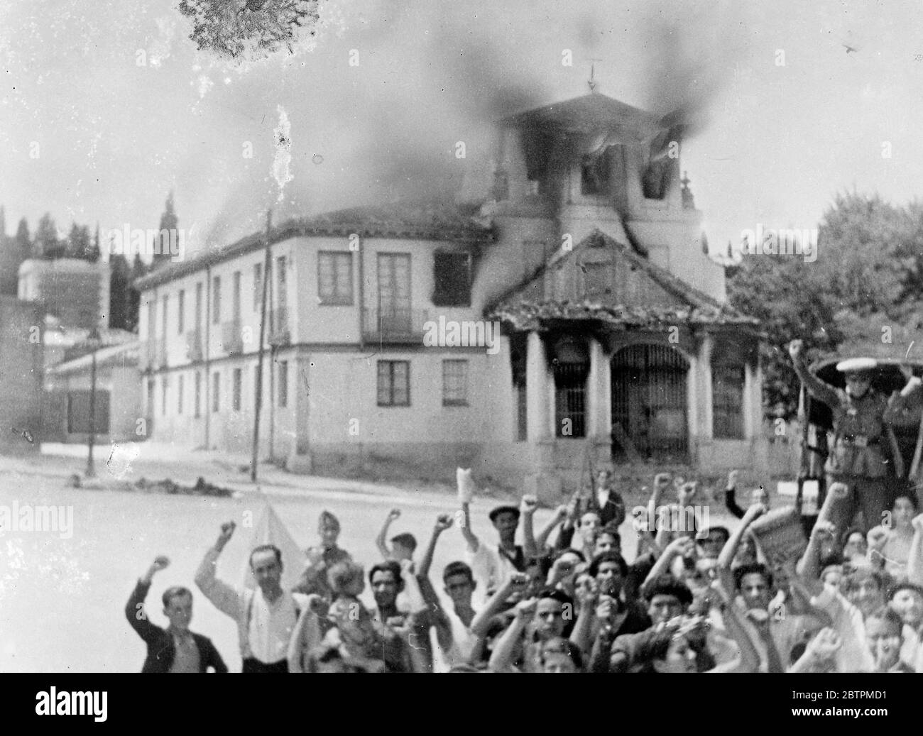 Church burning near Madrid . Communits salute being given by gov supporters . c. 25 July 1936 Stock Photo