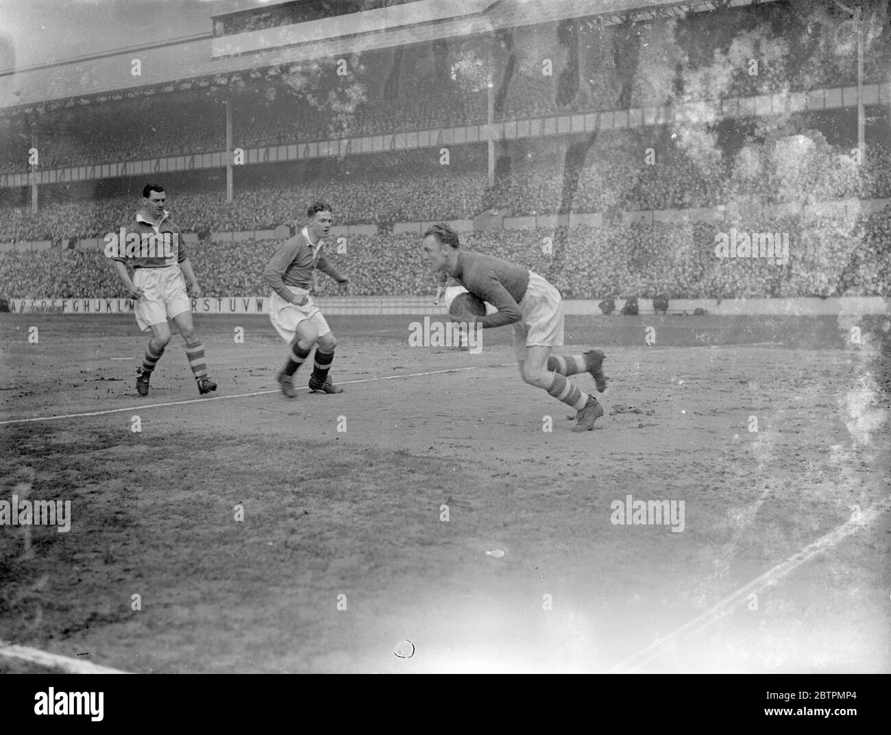 Cup tie at Tottenham . Tottenham Hotspur and Preston North End met in the sixth round of the F A Cup at WHite Hart Lane . Photo shows , John Alfred Morrison of Spurs rushing the Preston goalkeeper , George Holdcroft . 6 March 1937 Stock Photo
