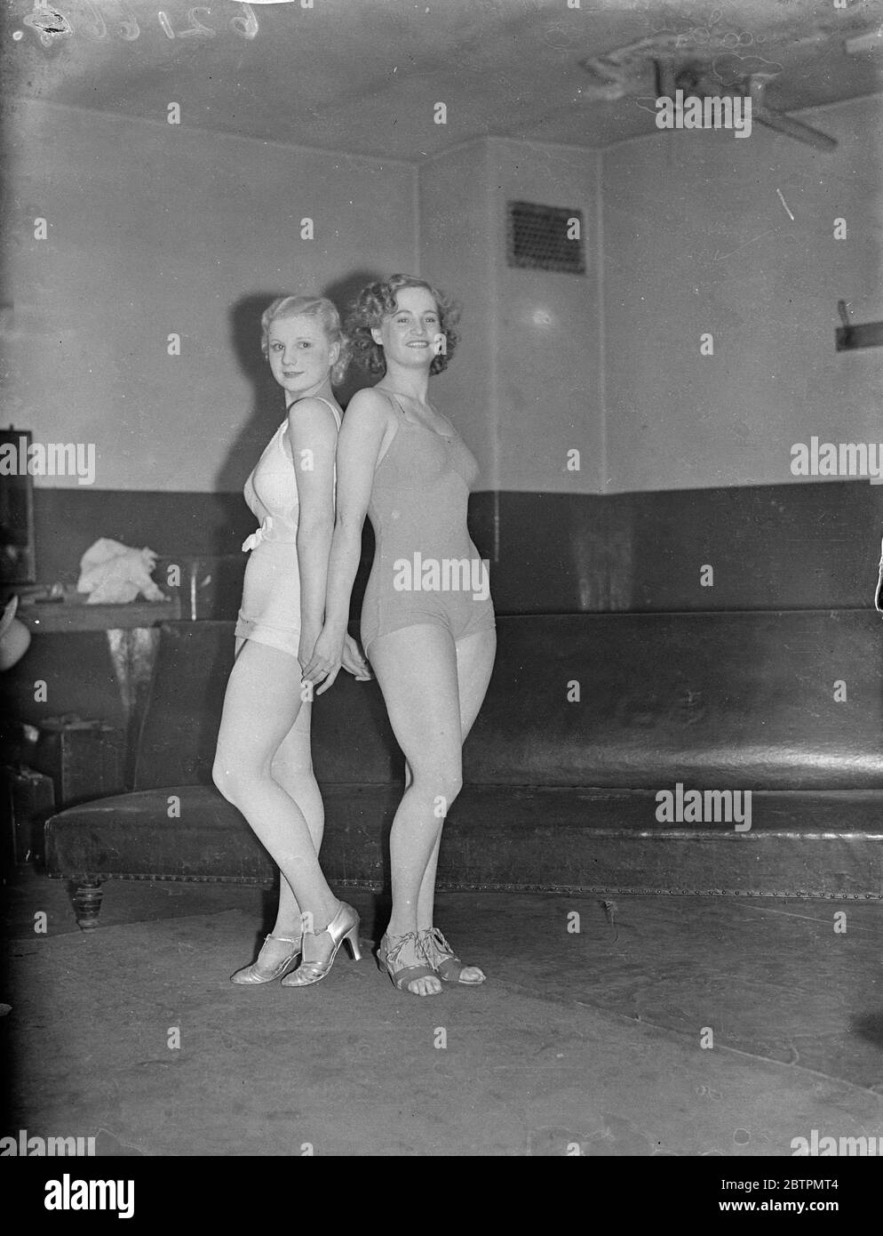 Lancashire's most beautiful twins. Daisy Robinson and Rosie Robinson, 17 1/2-year-old twins from Oldham, Lancaster, were competitors in a contest to find the girl with the perfect figure at Holborn Empire, London. Daisy carried off the first prize and Rose was fourth. Girls from all over the country competed. Photo shows: Daisy Robinson (right) and Joyce Fowler of Halifax was second. 10 March 1937 Stock Photo
