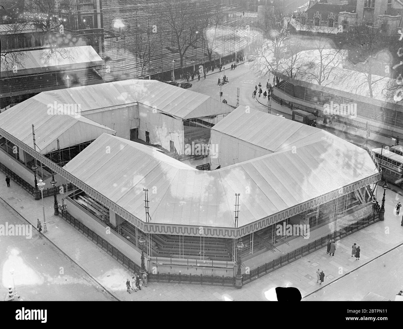 Coronation 'arena'. A birds eye view of the Coronation grandstands, looking something like a sports arena, which now occupy all the centre of the Parliament Square, Westminster. These seats will provide an excellent view of the procession new Westminster Abbey. 14 April 1937 Stock Photo