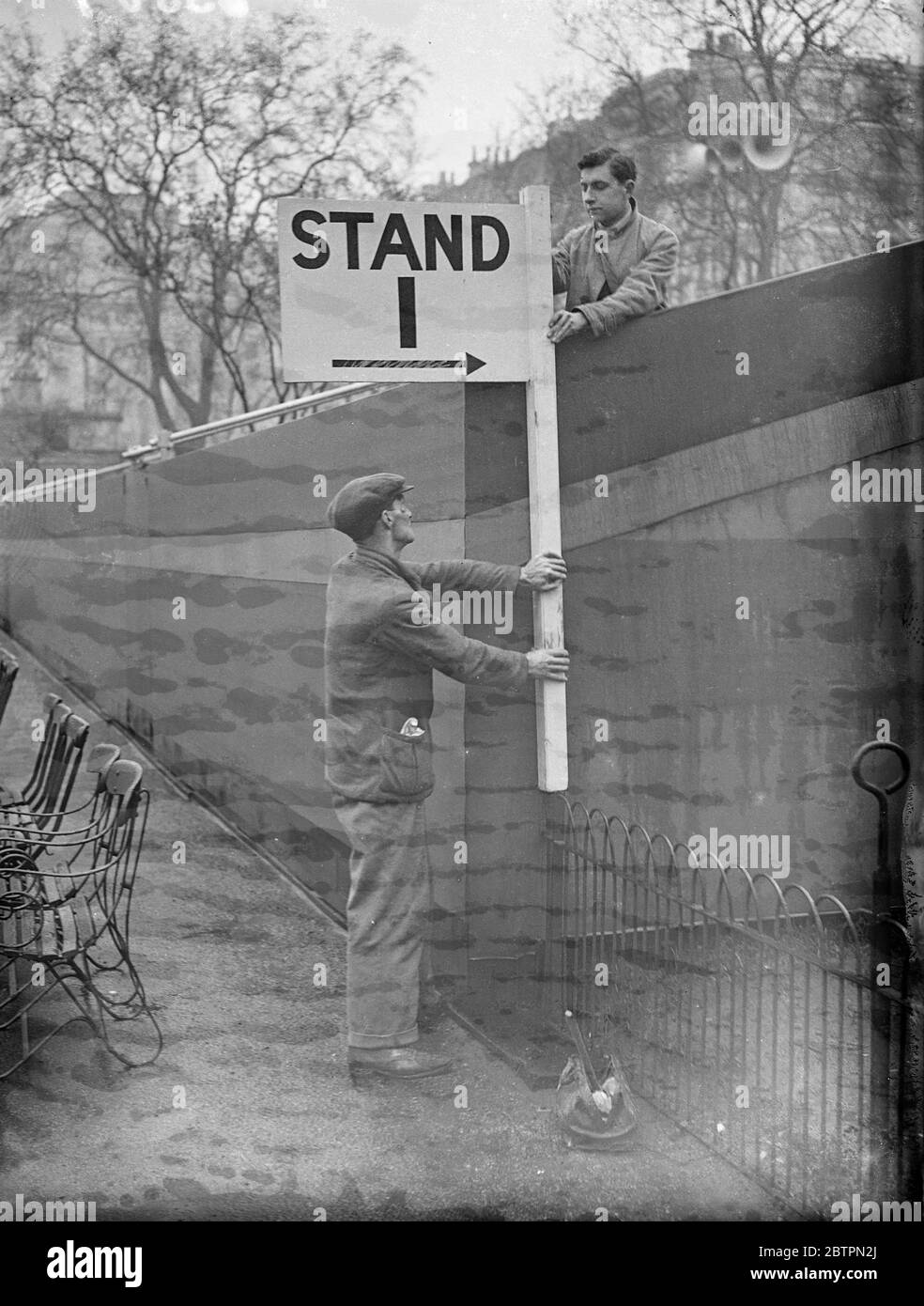 Coronation sound and number 1. The Coronation stands in Hyde Park near Marble Arch are now being numbered so that spectators were be able find their seats. Photo shows, the first number being fixed to a Coronation strand in Hyde Park, Marble Arch end. 17 April 1937 Stock Photo