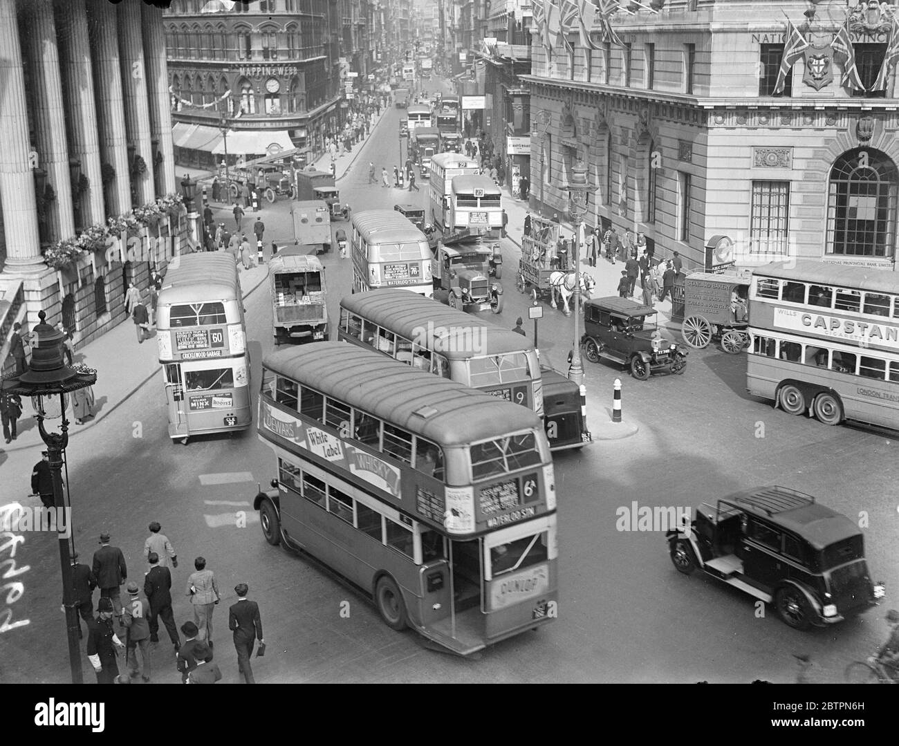 Buses 'as usual'. The traffic stream at the bank of England takes on its normal appearance with the return of the buses. 28 May 1937 Stock Photo