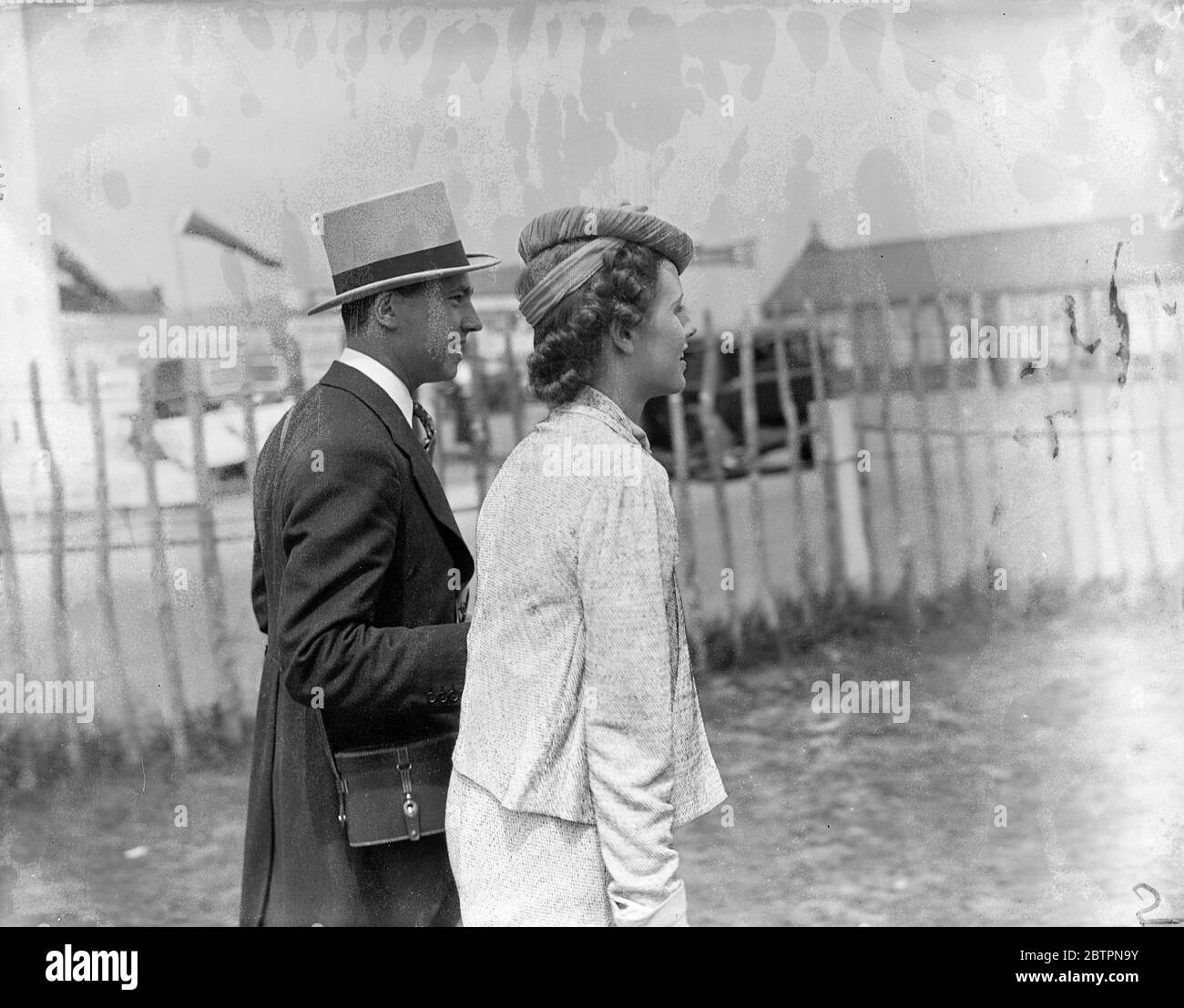 Scroll fashion at Epsom. A unusual and attractive fashion seen on the course at Epsom on Ladie's Day. Photo shows: Mrs G. Wolff wearing a particularly smart hat. Swathed with crepe-de-Chine, which finished in a bow, it was held to the head by a band. 4 June 1937 Stock Photo