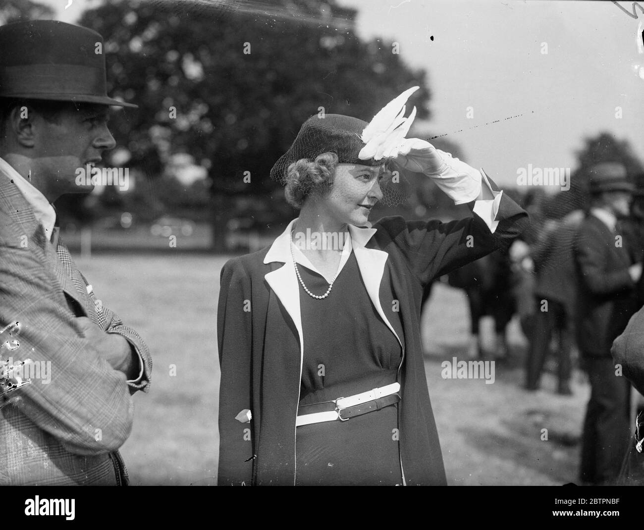 Bird on the hat. A bird of paradise hat decoration worn by Miss Alison Lawson at the polo match between the Air Force and the Navy, in which the Duke of Gloucester played for the Air Force, at the Ranelagh club, Barnes. 10 June 1937 Stock Photo