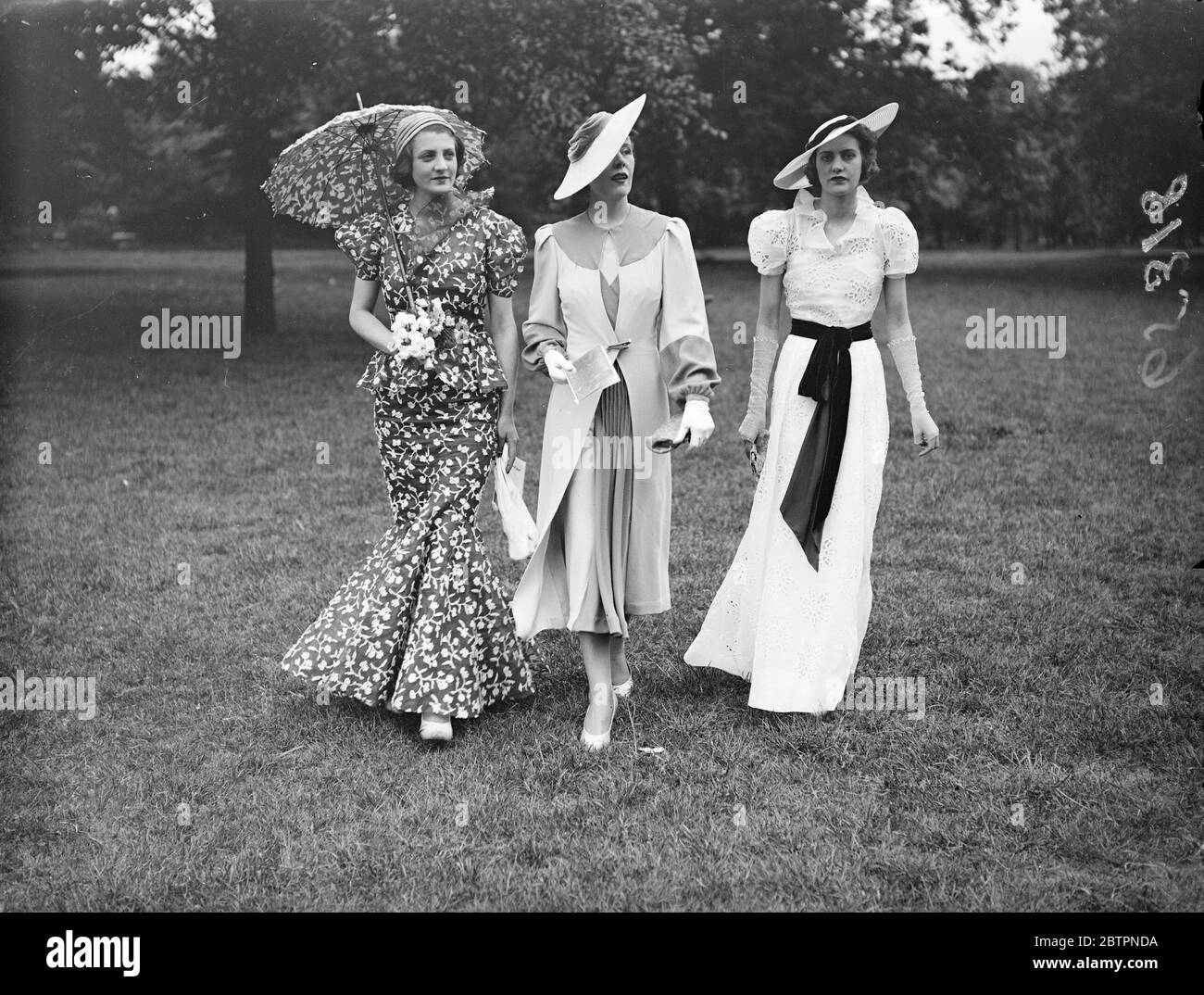 Fashions for Ascot. Three of the exquisite addresses which will be seen on the course when Ascot, most fashionable event of the season, opens next week. These fashions are by Ulick Philippe of London. 8 June 1937 Stock Photo