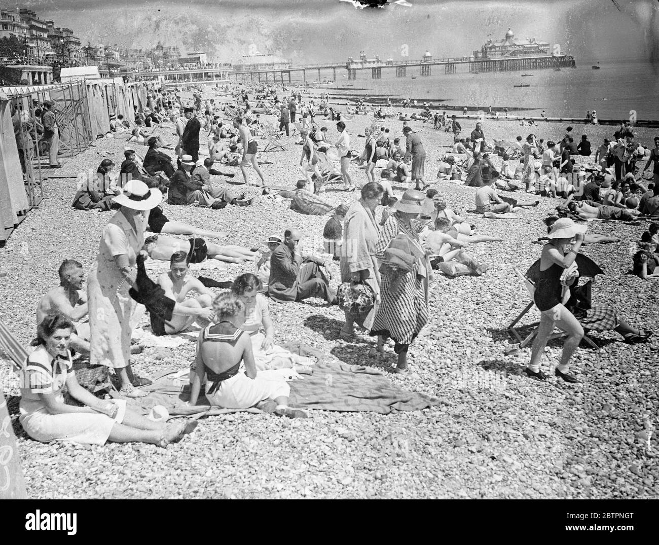Sunday crowds at Eastbourne. Eastbourne was crowded with Sunday visitors who enjoyed the warm sunshine and sea breezes. Photo shows: the beach crowded with visitors at Eastbourne. 6 June 1937 Stock Photo