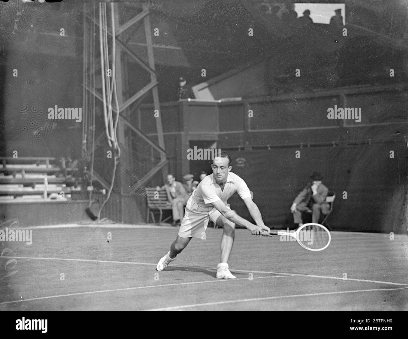 McGrath's double trip. Vivian McGrath, the Australian, uses both hands for a stroke during his match on Court 1 with M Ellmer (Switzerland) in the Wimbledon tennis championships. 21 June 1937 Stock Photo