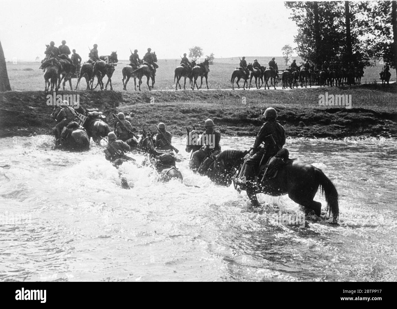 Dragoons patrolled Czechoslovak frontiers. Dragoons of the Czechoslovak Army riding through a ford as they constantly patrolled the frontiers. 4 Spetember 1938 Stock Photo