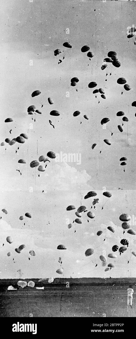 Parachutists fill the sky. Mass parachute descents and mimic warfare figured in a thrilling aeronautical display at the aerodrome of the Central Kosarev Aero Club at Tushine, Moscow, Russia staged at Festival of Soviet Aviation. Photo shows, the sky filled with parachutists as they made a mass jump at the display. 23 August 1938 Stock Photo