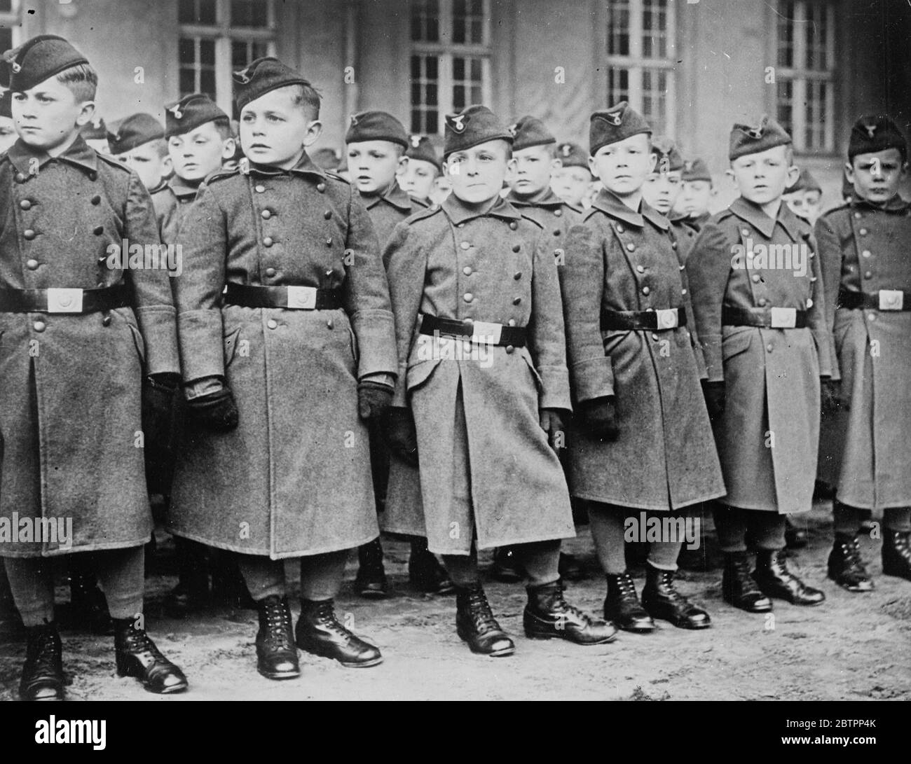 Growing up, the soldiers. Boys belonging to the the military orphanage at Potsdam, wearing their smart uniforms at the official 'handing over' ceremony of the Orphanage. The orphanage has been established under the protection of the army to give shelter to military orphans. 29 January 1938 Stock Photo