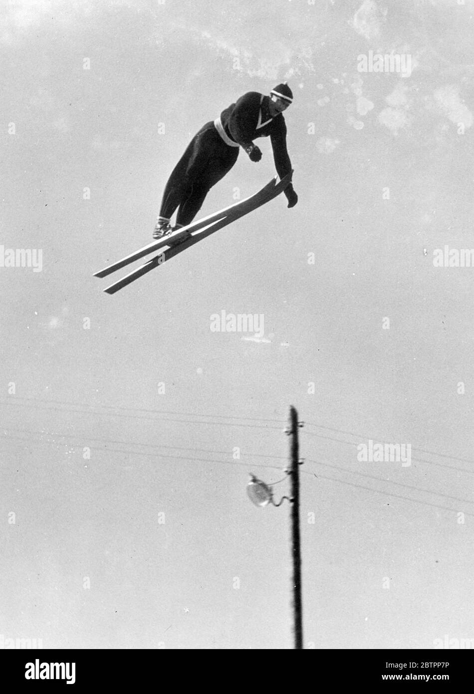 Skier in the sky. Reider Anderson, the Norwegian, soaring through the sky as he trains for the world skiing Championships at Lahtis, Finland. Stock Photo