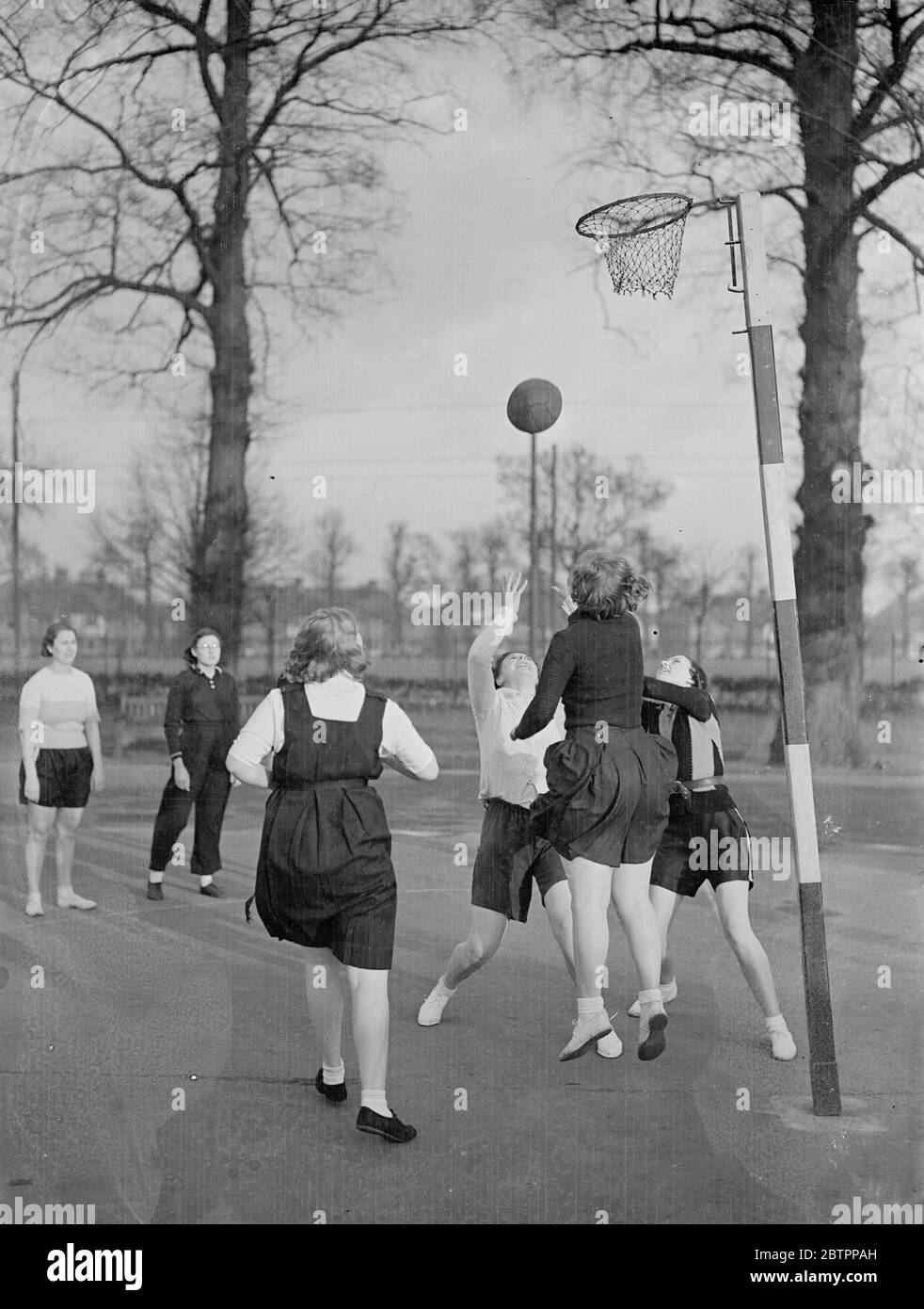 Netball sprites. A shot for the net during the netball match of the Mitcham Ladies Athletic club at Mitcham, Surrey. 29 January 1938 Stock Photo